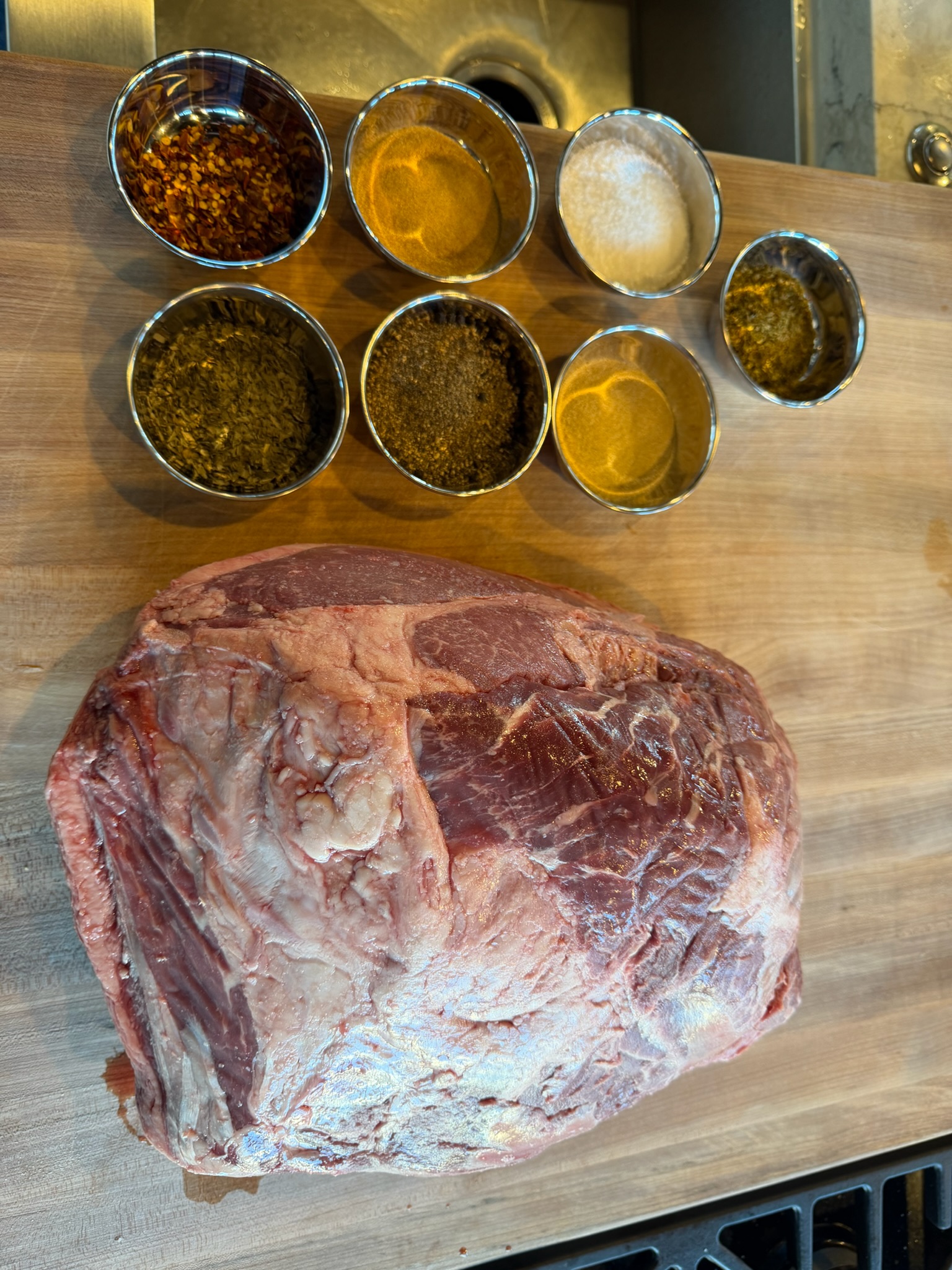 Bottom round roast and measured seasoning ingredients.