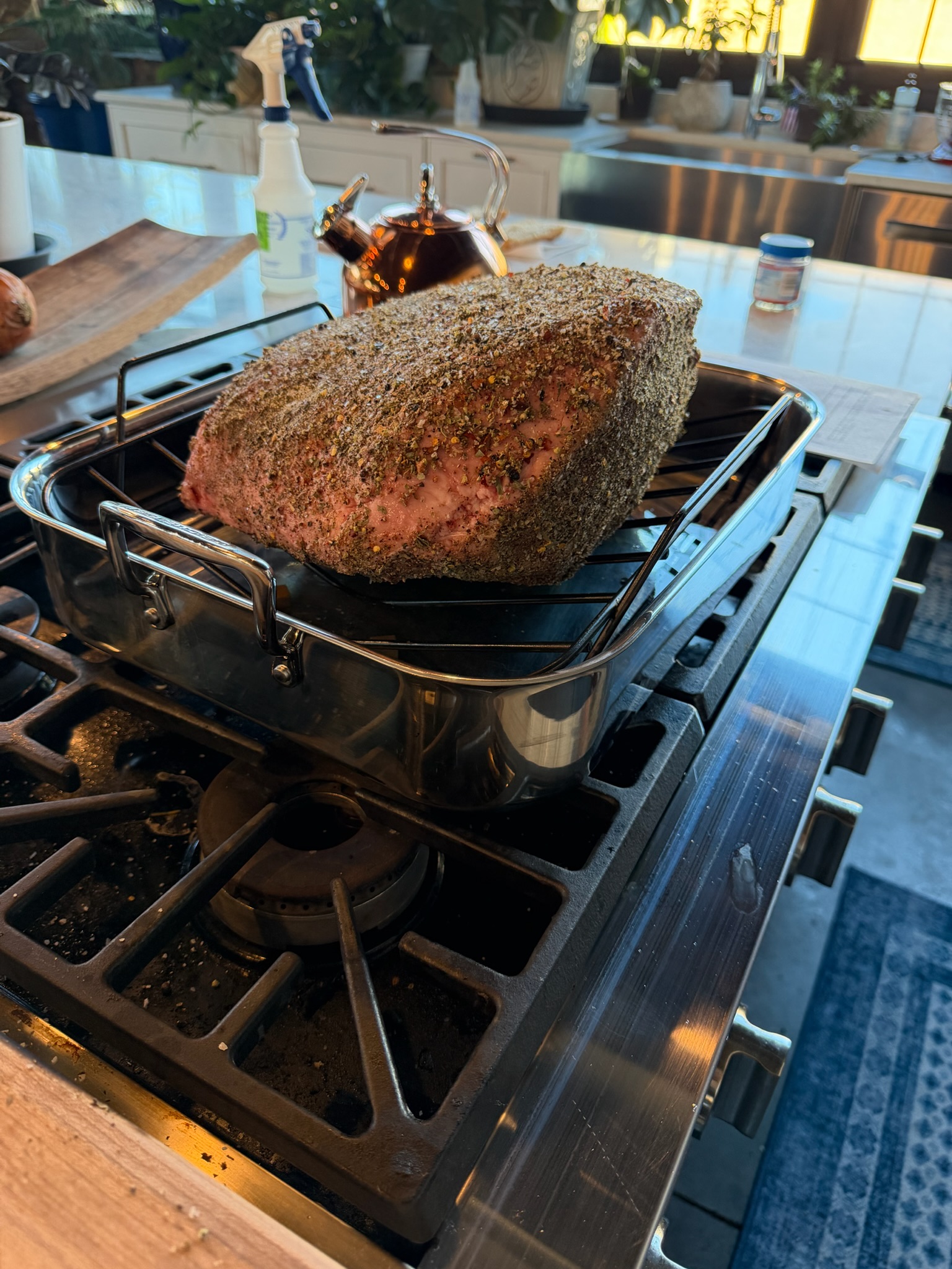 The roast resting on its rack above the jus.