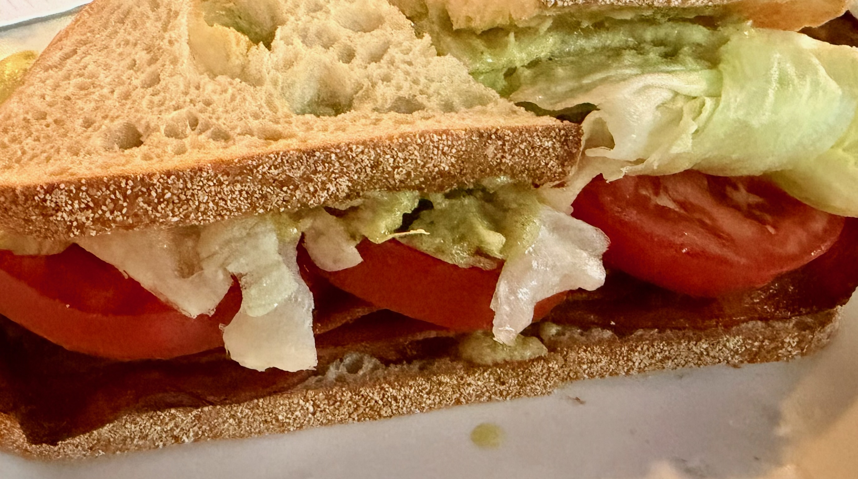 Close-up of the Monster BLT with bacon, tomato and lettuce.