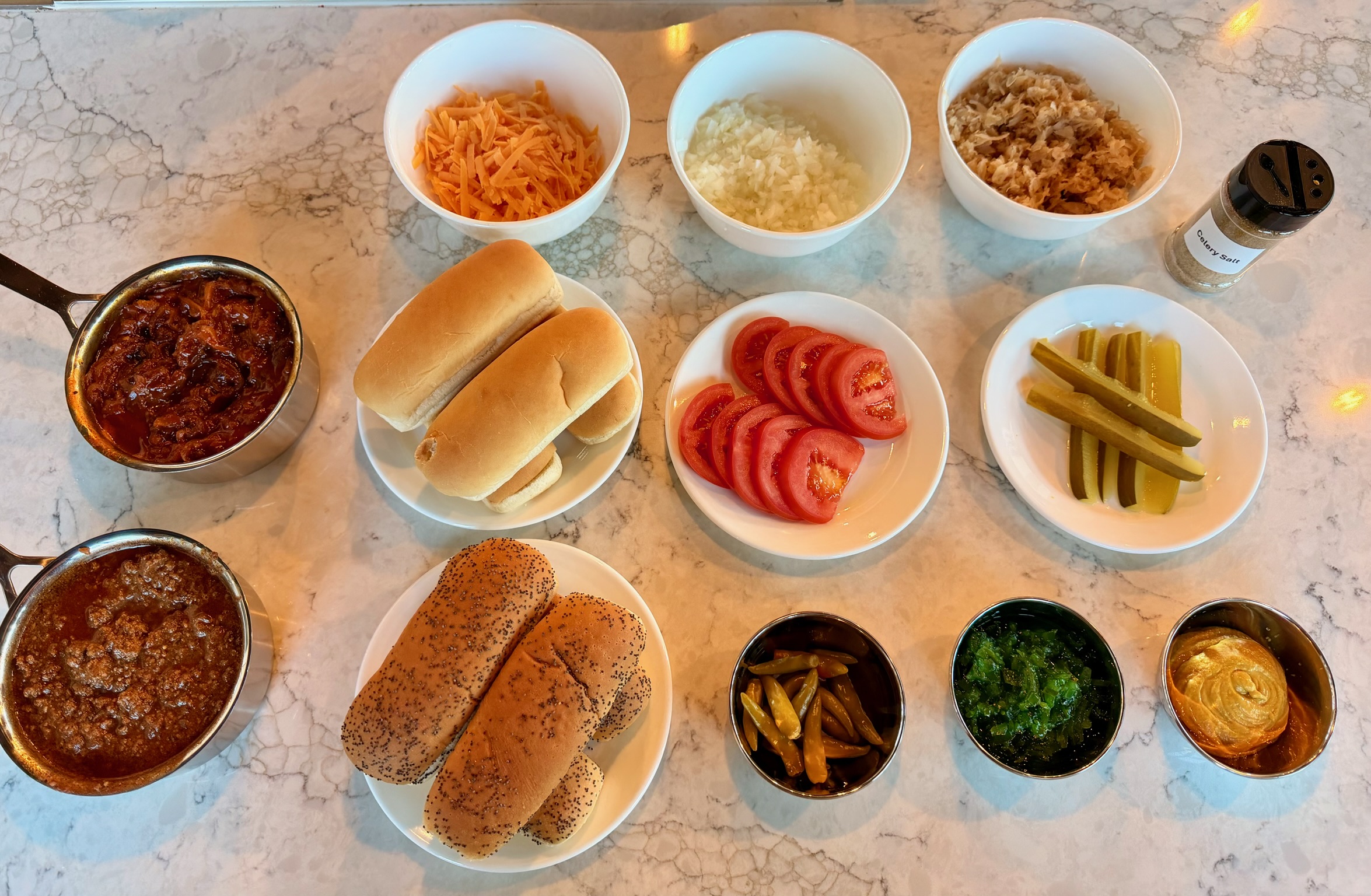 Hot dog buns and toppings laid out for assembly.