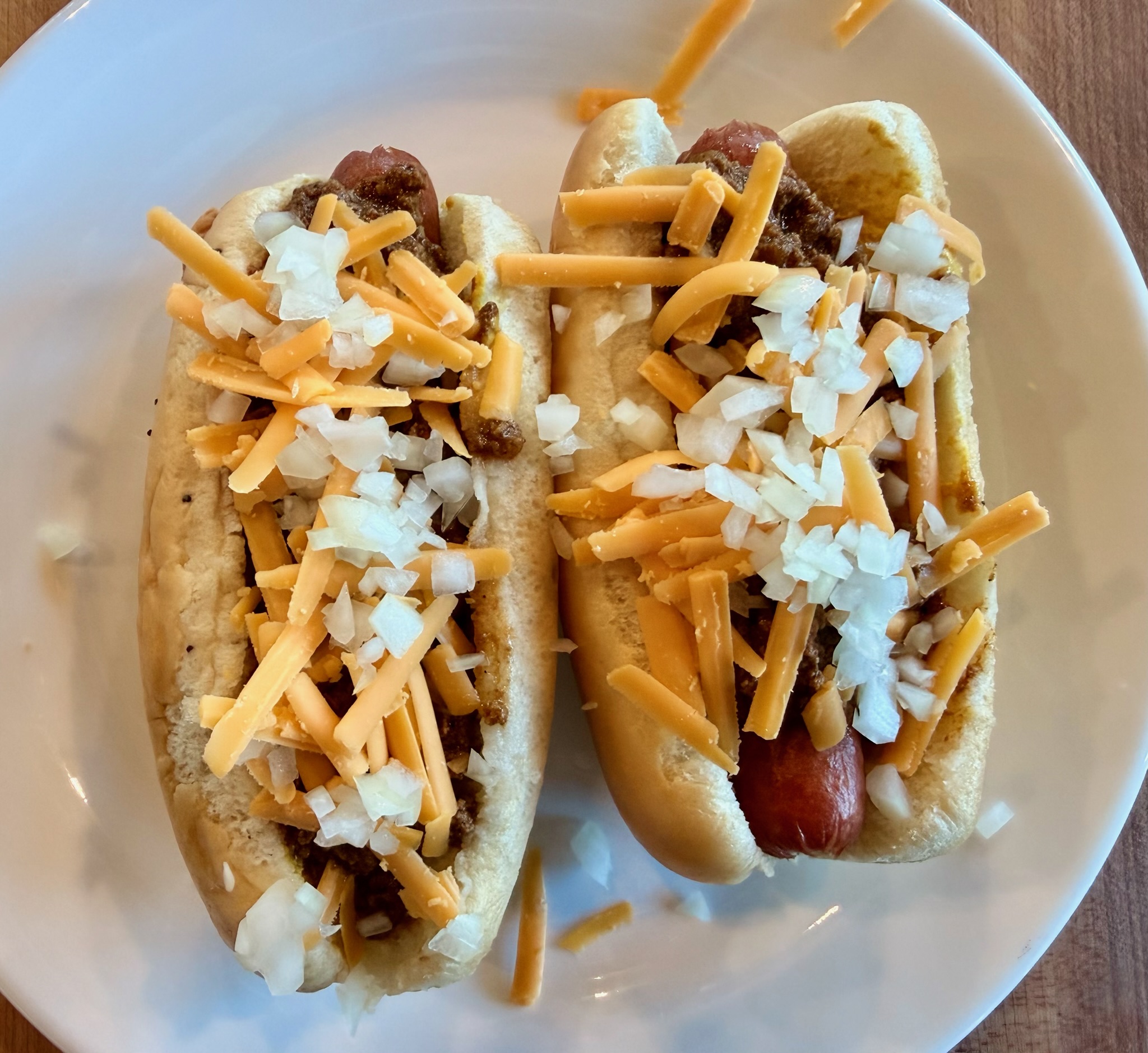 Chili cheese dogs with shredded cheddar.